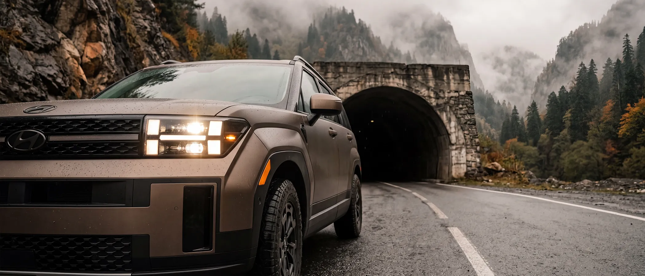 Rental Hyundai SantaFE XRT with headlights on near a mountain tunnel or misty road in Georgia